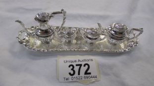 A miniature silver plate tea set on tray.