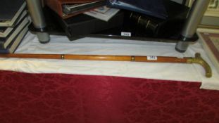 A collapsible walking stick with brass handle