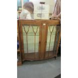 A mid 20th century glazed display cabinet.