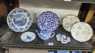 A quantity of blue and white plates, napkin rings, teapot etc.