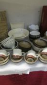 A quantity of as new stoneware dishes and mugs including Denby