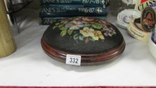 A Victorian style button footstool with floral tapestry top