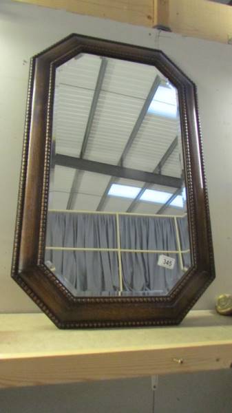 An Edwardian oak framed bevel edge mirror