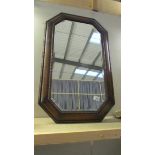 An Edwardian oak framed bevel edge mirror