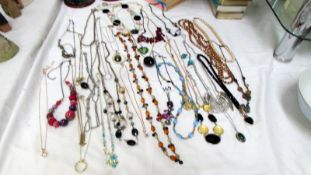 A mixed lot of costume jewellery including necklaces.