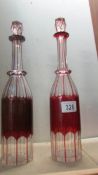 A pair of overlaid ruby cut glass decanters a/f