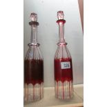A pair of overlaid ruby cut glass decanters a/f