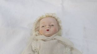 A baby doll with bisque head, hands and feet, no makers mark.