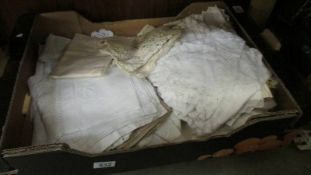 A box of vintage linen including table cloths etc.