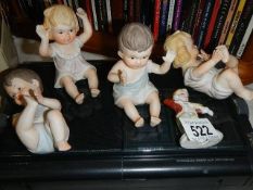 A quantity of porcelain piano babies etc.,