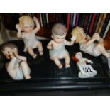 A quantity of porcelain piano babies etc.,