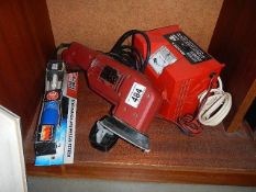 A battery charger, sander etc.,