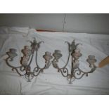 A pair of wall mounting candleholders.