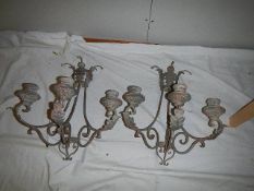 A pair of wall mounting candleholders.