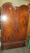 A small mahogany wardrobe with arched doors. (Collect only)