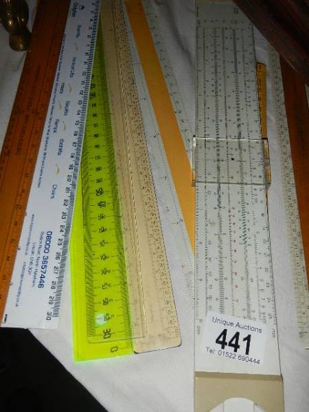 A quantity of rulers including slide rule.