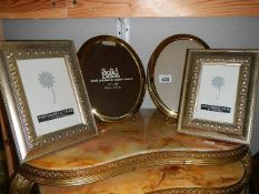 A quantity of brass and other photo frames.