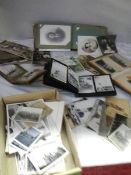 A mixed lot of old postcards and photographs.