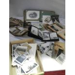 A mixed lot of old postcards and photographs.