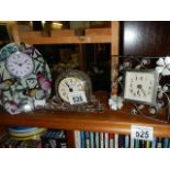 A crystal glass clock and two others.