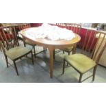 An oval teak dining table with five chairs. (Collect only)
