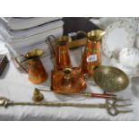 A set of three graduated copper jugs, brass toasting fork etc.,