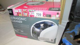 A boxed ultrasonic cleaner.