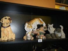 A Tiger figure, two dogs and an otter.