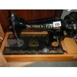 A vintage sewing machine by The Gold Leaf Sewing Machine Company. (collect only)