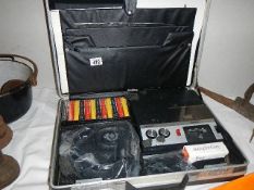 A cased cassette player with cassettes. (Collect only)