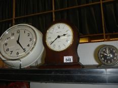 A wall clock and two other clocks.