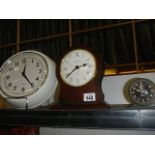 A wall clock and two other clocks.