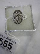 A silver marcasite ring.