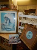 A framed and glazed picture of an American Indian, one other and a book.