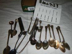 A mixed lot including cocktail sticks, sugar tongs, spoons etc.,