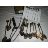 A mixed lot including cocktail sticks, sugar tongs, spoons etc.,