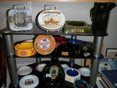 A quantity of pub ashtrays and a Black Lable jug.