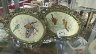 Two oval pictures on silk of birds.