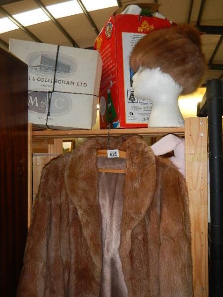 A fur jacket, fur hat and hat box.