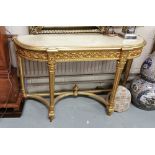 Carved Gilt Console Table, with a beige marble top over a raised floral decorated frieze, curved