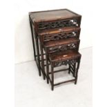 Nest of 4 Chinese graduating hardwood Tables with decorative floral fretwork, bamboo style legs,