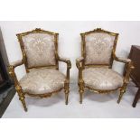 Matching Pair of Carved Gilt Framed Drawing Room Armchairs, silver and beige covered seats and