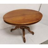 Oval topped low walnut Centre Table, pod base with 4 splayed feet, 1.15mW x 0.80mD x .068mH