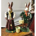 A Pair of Buck and Doe (standing) Rabbits, dressed in colourful costumes, carrying baskets, each