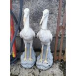 Matching Pair of Painted Concrete Garden Stork Figures, white on grey painted stumps, each 105cm