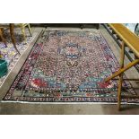 Washed light red ground Persian Carpet, Heriz region, floral pattern and central medallion, 2.44m