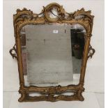 Antique Wall Mirror in a carved giltwood frame, in the Rocco style (mirror is blackened) 103H x