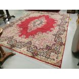 Persian Wool Carpet, with a central medallion and multiple floral borders, red ground with light