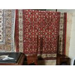 Red ground Kashmir Rug, all over floral pattern, gold border, 1.55m x 2.4m