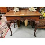 Irish 19th C Georgian style mahogany side table with decorative carved frieze centered on a stylized